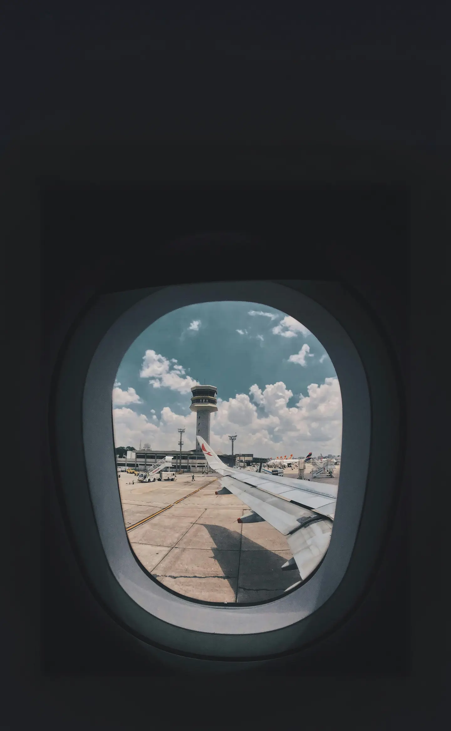 View from an airplane window at an airport tarmac